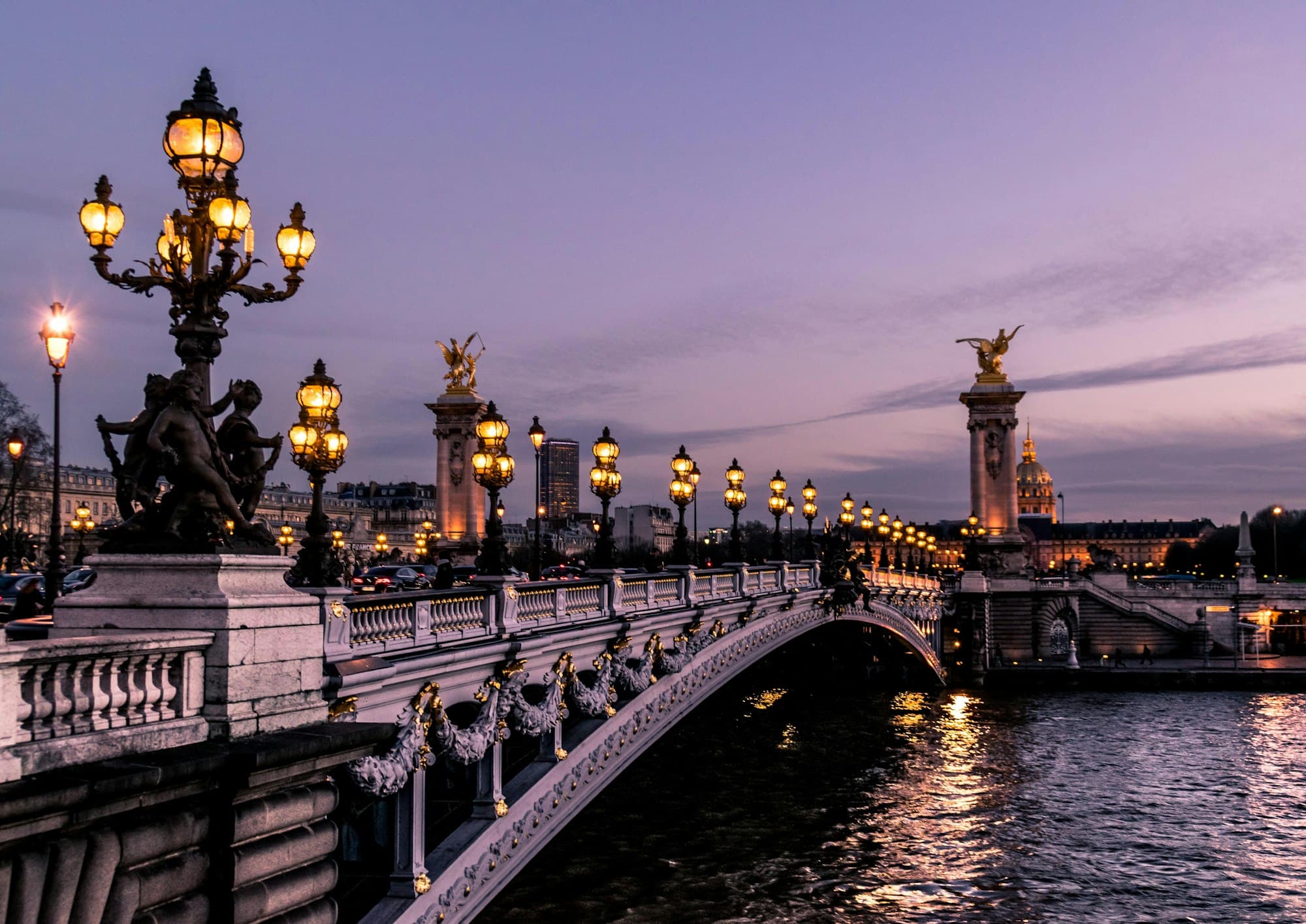 A historic European capital city along the water at dusk