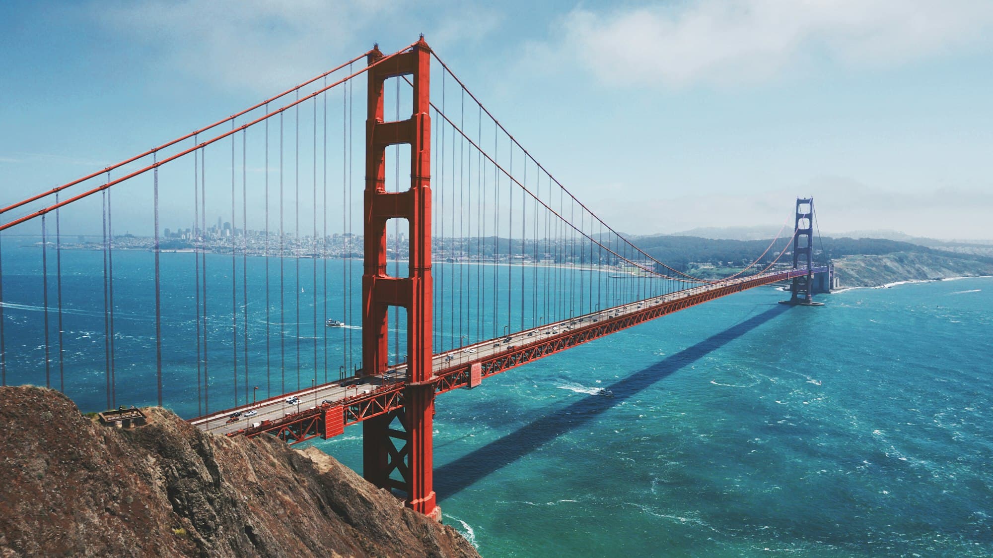 Golden Gate Bridge emerging from morning fog over San Francisco Bay