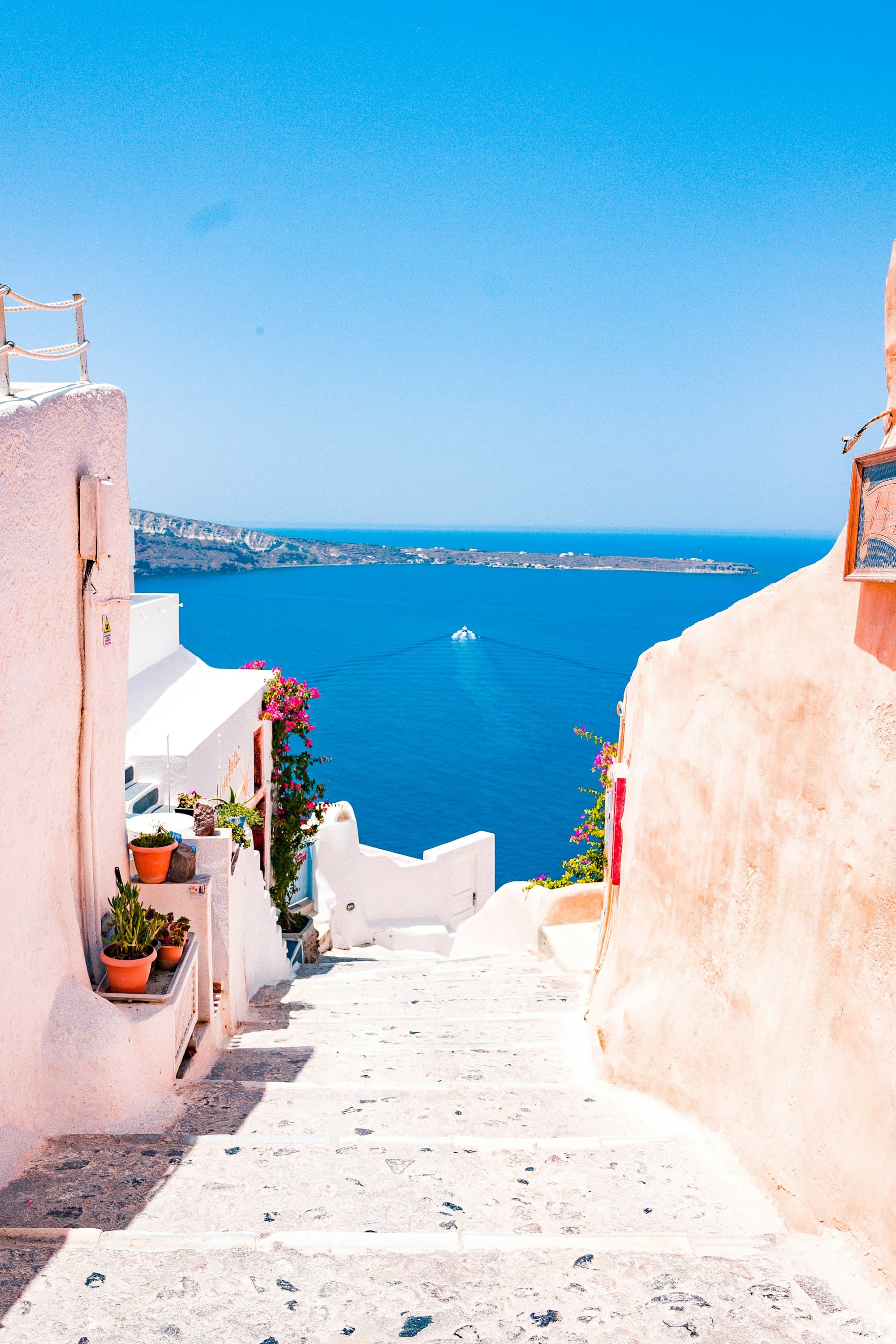 White-domed blue-roofed buildings overlooking the Aegean Sea in Santorini